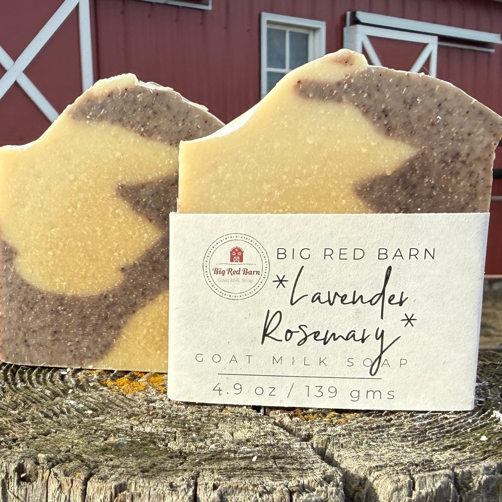 Goat milk soap with a visible label in front of a red barn.