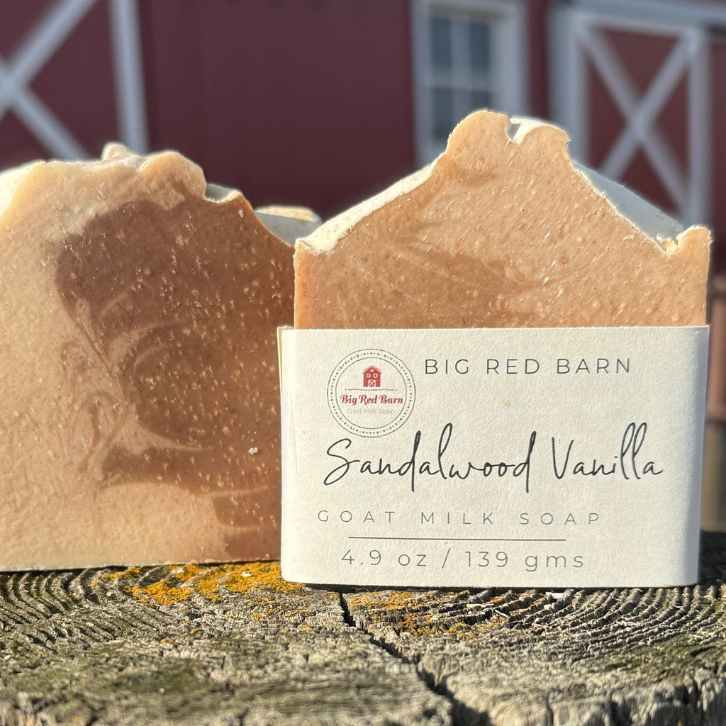 Bar of sandalwood vanilla soap with a Big Red Barn label against a barn background