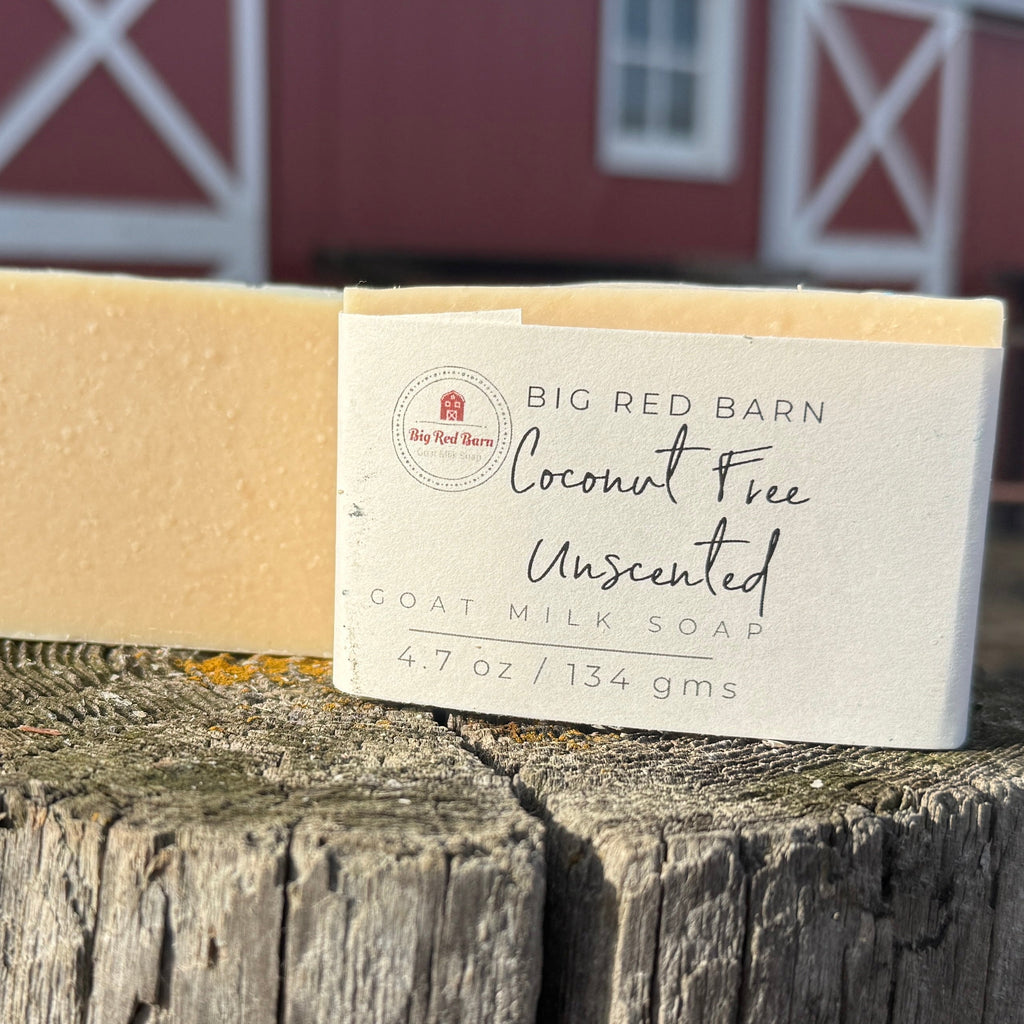 Bar of soap with a label on a wooden post in front of a red barn.